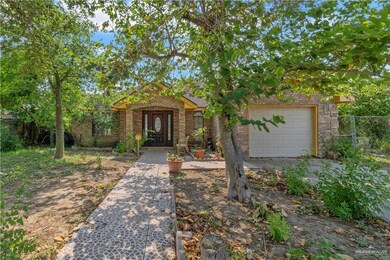 View of property hidden behind natural elements featuring a garage