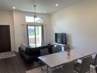 Dining space with ceiling fan and dark hardwood / 