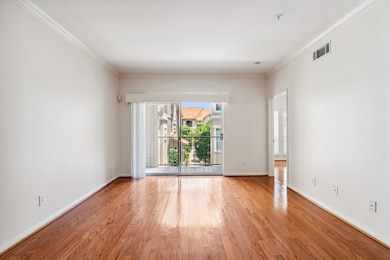 Generously sized living area with warm hardwood fl