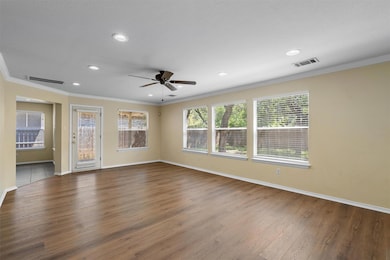 Empty room featuring ornamental molding, wood finished floors, recessed lighting, and ceiling fan