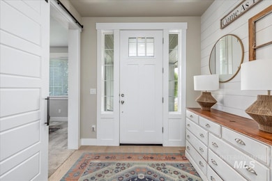 Foyer with a barn door and plenty of natural light