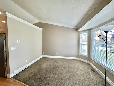 Formal or sitting room with bay box window and lots of natural light.  Vaulted ceiling.