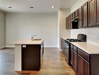 Kitchen featuring sink, a center island with sink,