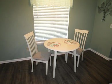 Dining room featuring wood finished floors and baseboards