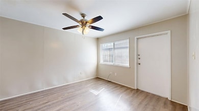 Empty room featuring light wood-style floors and ceiling fan
