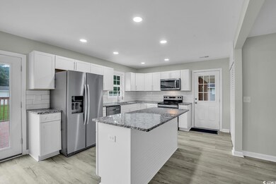 Kitchen with stainless steel appliances, white cab