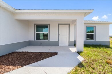 View of exterior entry featuring stucco siding