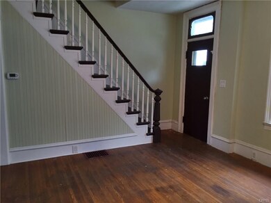 Original door, transom & stair rail.