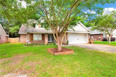 View of front of home with a front yard, brick sid