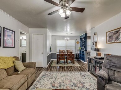 Living room featuring ornamental molding, dark har