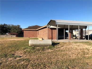 Rear view of house featuring brick siding