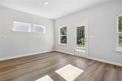 Empty room featuring plenty of natural light and wood finished floors