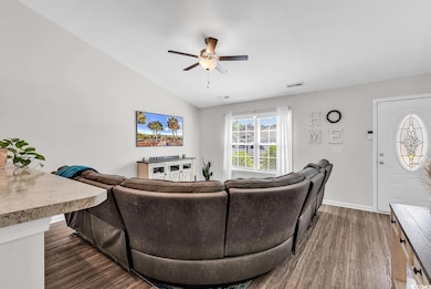 Living area with lofted ceiling, wood finished flo