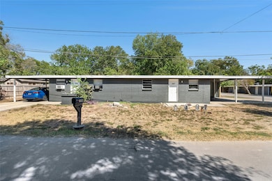 Ranch-style house featuring a carport, brick siding, and concrete driveway