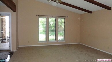 Huge living room with new carpet and beamed ceilin