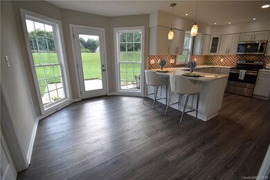 Eating area in kitchen with door to back yard.