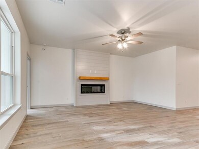 Unfurnished living room featuring baseboards, visi