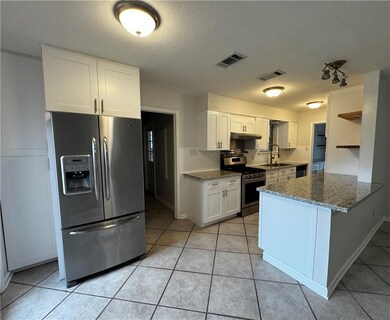 Open to the den with a bar area for seating