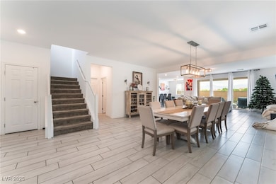 Dining room with stairway, light wood-type floorin