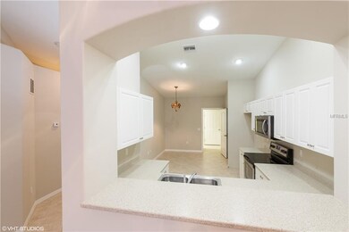 ARCHED WINDOW OPENING OVERLOOKS LIVING/DINING ROOM