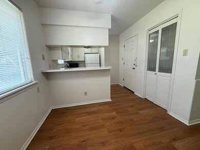 Kitchen with a peninsula, white cabinets, freesta