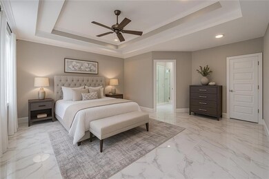 Primary Bedroom featuring a tray ceiling, baseboards, recessed lighting, and marble finish floor Viritually Staged