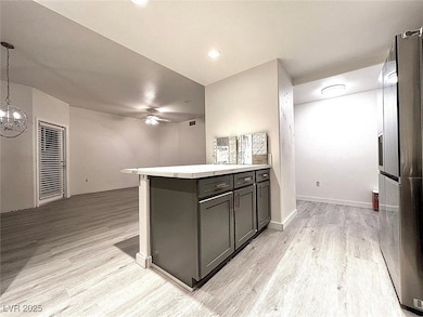Kitchen featuring ceiling fan with notable chandel