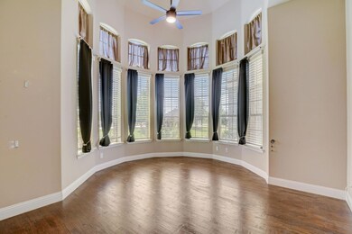 Unfurnished room featuring ceiling fan, a towering