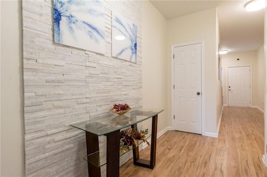 Hallway with light hardwood / wood-style flooring