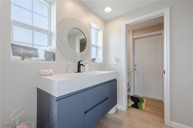 Bathroom with vanity and hardwood / wood-style flo