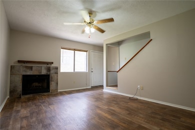Unfurnished living room with a ceiling fan, wood f