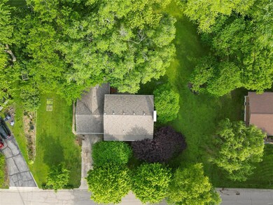 Lovely yard with several types of trees offering multiple locations to relax and play.