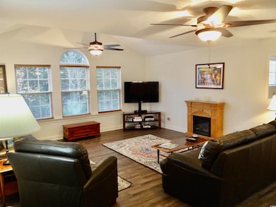 Living area, dark wood finished floors, lofted cei