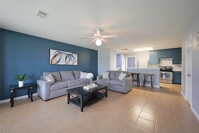 Living area with light tile patterned flooring, ba