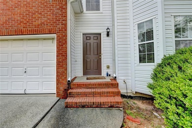 Entrance to property featuring concrete driveway a