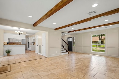 The living space is open to the den and kitchen ar