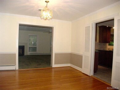 Formal dining room with oak floor, chair rail and 