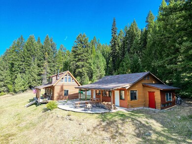 Rear view of house with a patio and a lawn