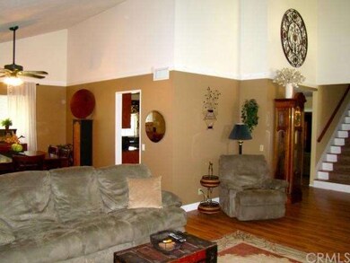 Living room facing entry, dining and kitchen. Glea