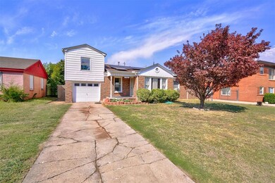 View of front of property featuring a garage, sola