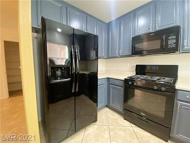 Kitchen with light countertops, light tile pattern