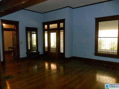 View is across living room toward front door,  doo