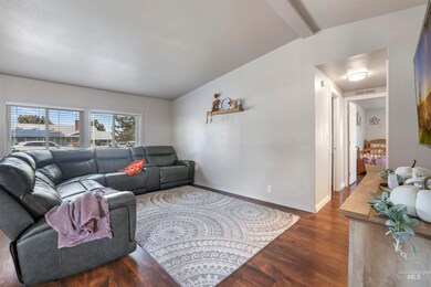 Living room with dark wood finished floors and baseboards