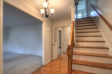 Foyer entry with gleaming hardwood floors.