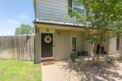 Property entrance featuring fence and brick siding