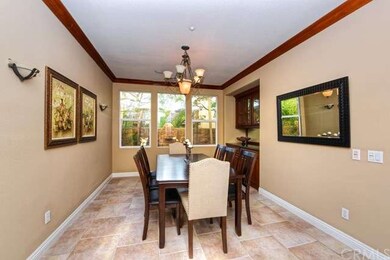 Formal Dining with Baseboards and Custom Lighting 
