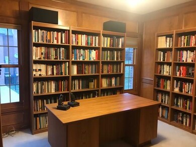 Spacious and elegant den with judges paneling, flu