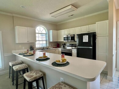 Kitchen featuring sink, kitchen peninsula, white c