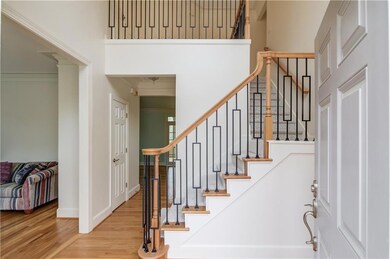 Entrance foyer featuring iron balusters on stairs,