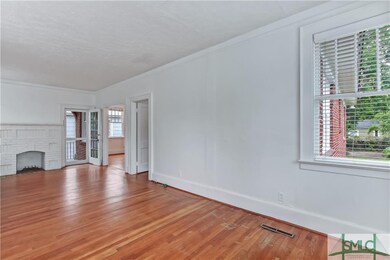 The vast living room has hardwood floors and a fir